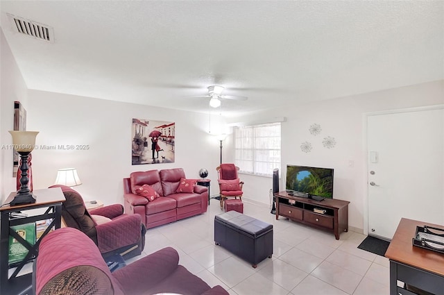 tiled living room featuring ceiling fan and a textured ceiling