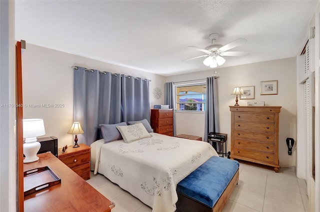 bedroom featuring light tile patterned floors and ceiling fan