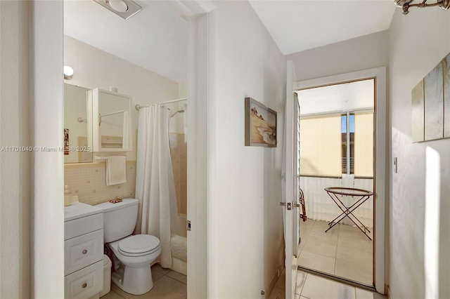 bathroom with toilet, curtained shower, tile patterned flooring, and backsplash