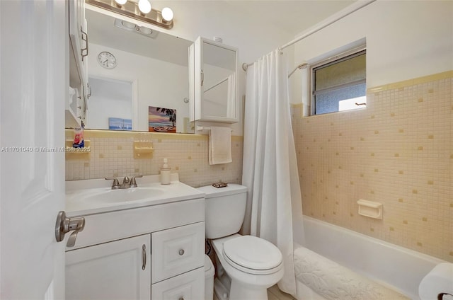 full bathroom with shower / bath combination with curtain, vanity, toilet, and tile walls