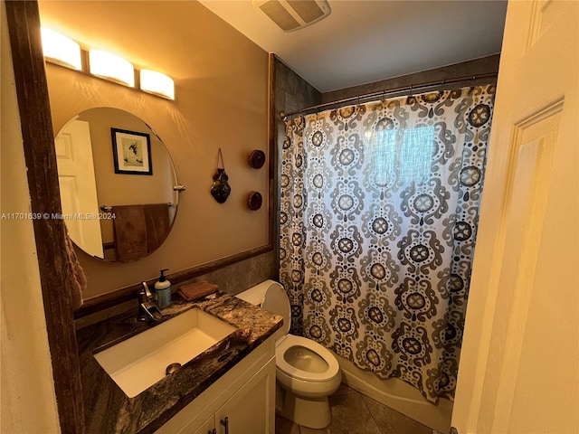 full bathroom featuring toilet, shower / bath combo, vanity, and tile patterned floors