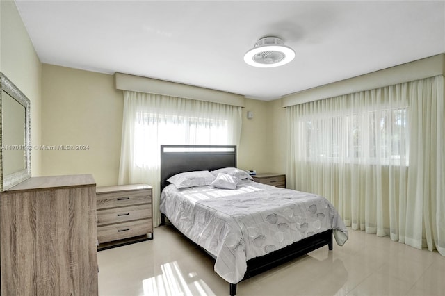 bedroom with light tile patterned floors