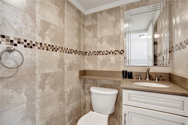 bathroom with vanity, toilet, tile walls, and ornamental molding