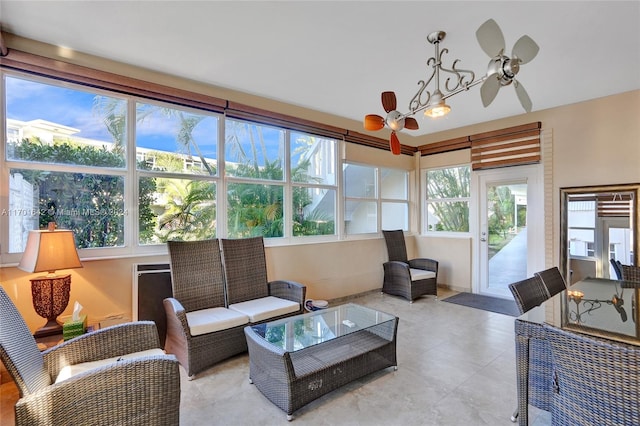 sunroom / solarium featuring a wealth of natural light and ceiling fan