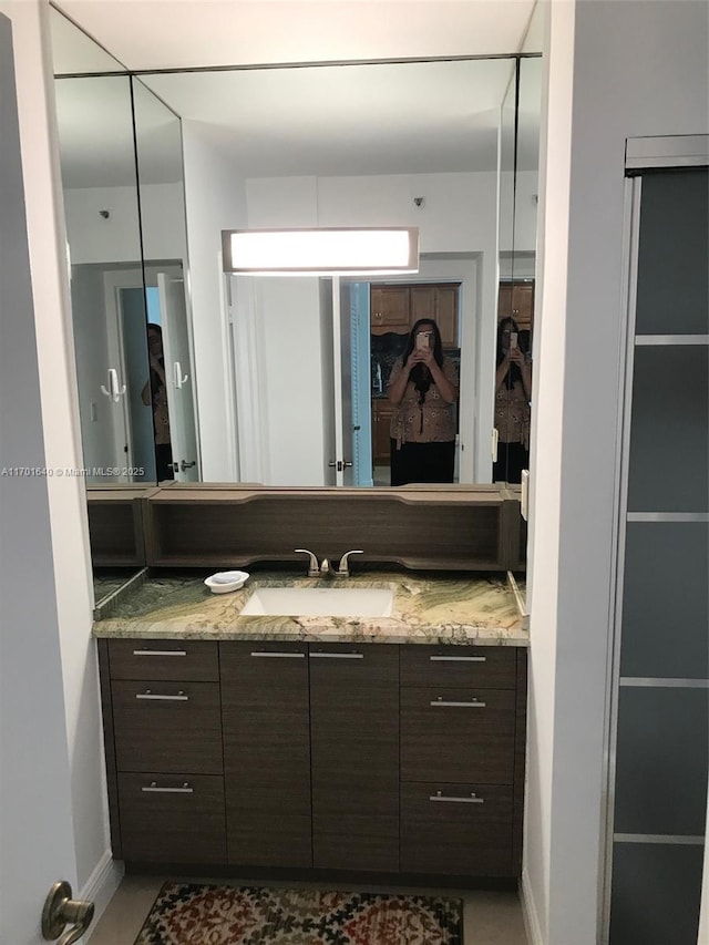 bathroom featuring tile patterned flooring and vanity