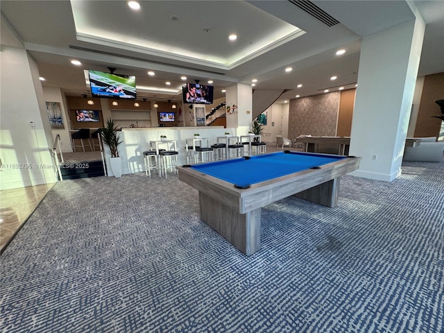 rec room featuring a raised ceiling, carpet, bar, and pool table