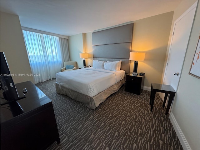 carpeted bedroom featuring baseboards