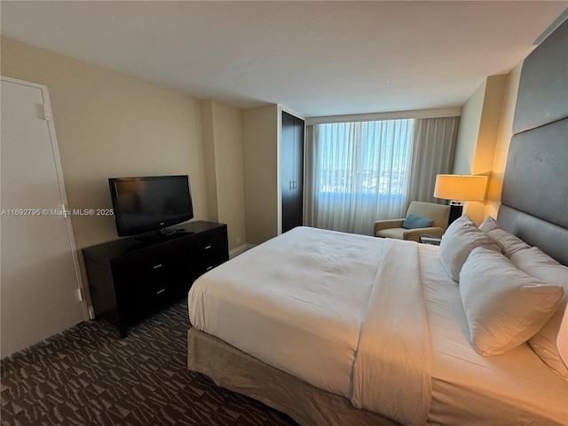 bedroom featuring dark colored carpet