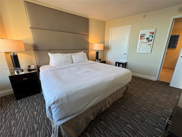 carpeted bedroom with baseboards