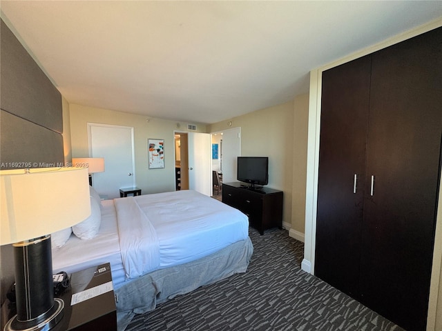 bedroom featuring carpet, visible vents, and baseboards