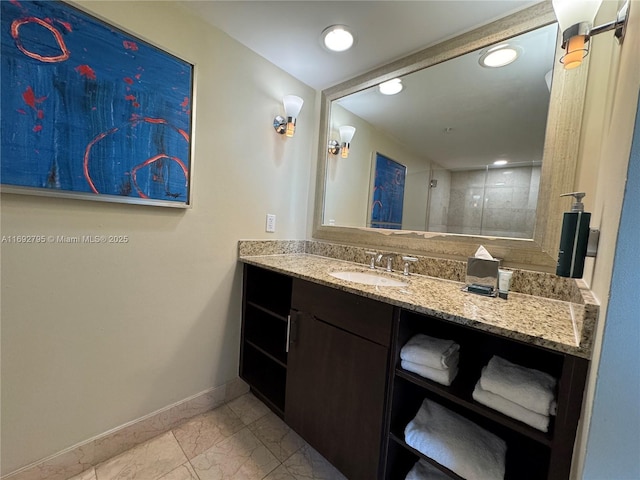 full bath featuring recessed lighting, vanity, baseboards, marble finish floor, and tiled shower