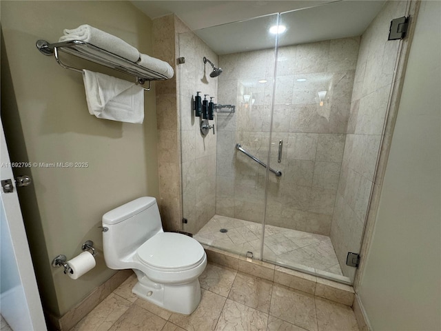 full bath with a stall shower, toilet, and baseboards