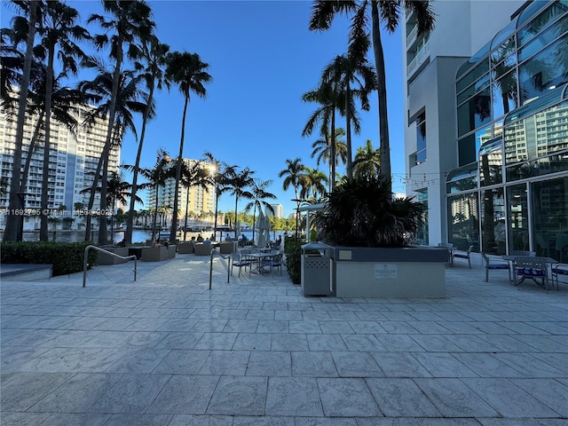 view of home's community with a patio area and a water view