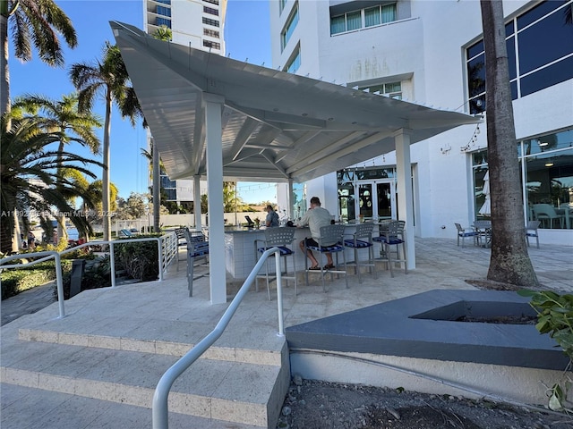 view of patio / terrace featuring outdoor dry bar and a gazebo