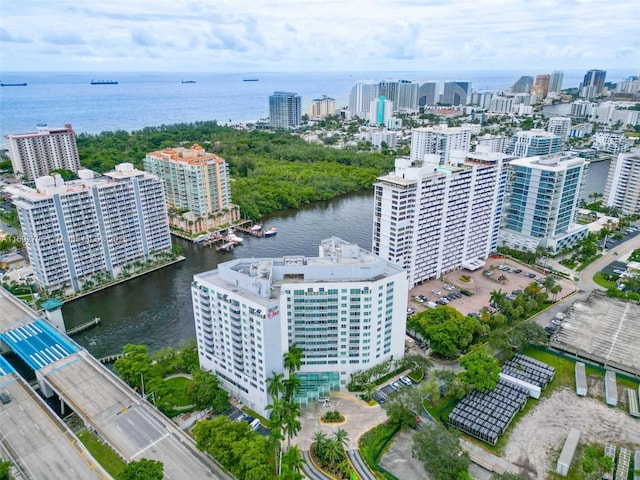 birds eye view of property with a view of city and a water view