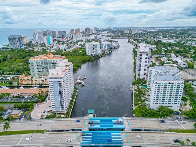 drone / aerial view featuring a view of city and a water view