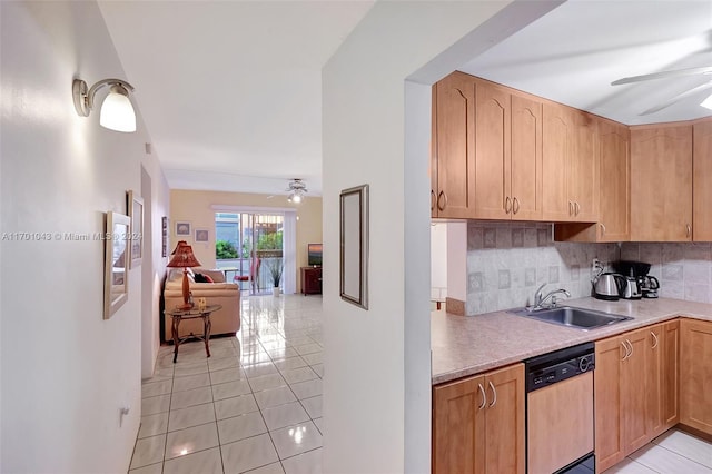 kitchen featuring dishwashing machine, light tile patterned flooring, ceiling fan, and sink