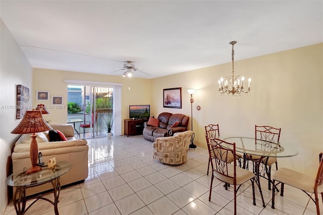 tiled living room featuring ceiling fan with notable chandelier