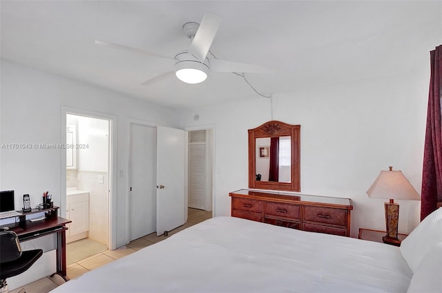 tiled bedroom featuring connected bathroom and ceiling fan