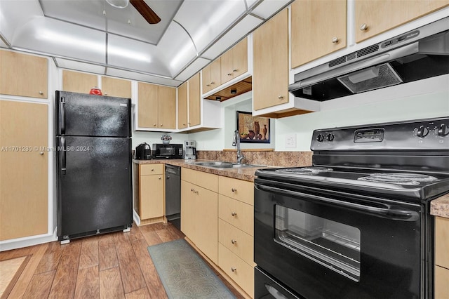 kitchen featuring light brown cabinets, black appliances, sink, ceiling fan, and light wood-type flooring