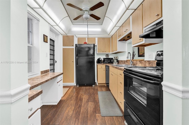 kitchen with ceiling fan, dark wood-type flooring, ventilation hood, a tray ceiling, and black appliances