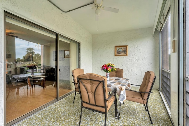 sunroom featuring ceiling fan