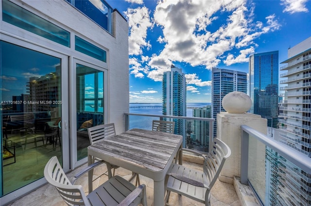 balcony with a view of city and a water view