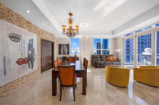 dining area featuring recessed lighting, a tray ceiling, a chandelier, and ornamental molding