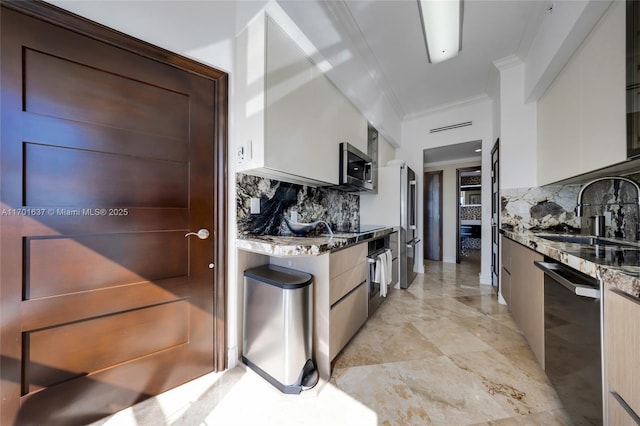 kitchen featuring stone counters, stainless steel appliances, ornamental molding, a sink, and modern cabinets