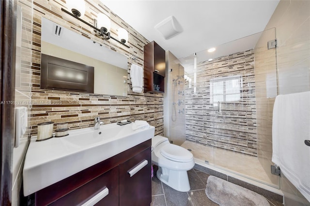 bathroom with tile walls, backsplash, toilet, a stall shower, and vanity