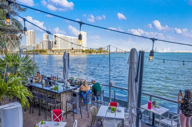 view of dock with a water view and outdoor dry bar