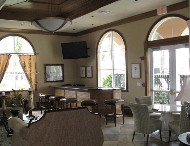 dining area with wood-type flooring and crown molding