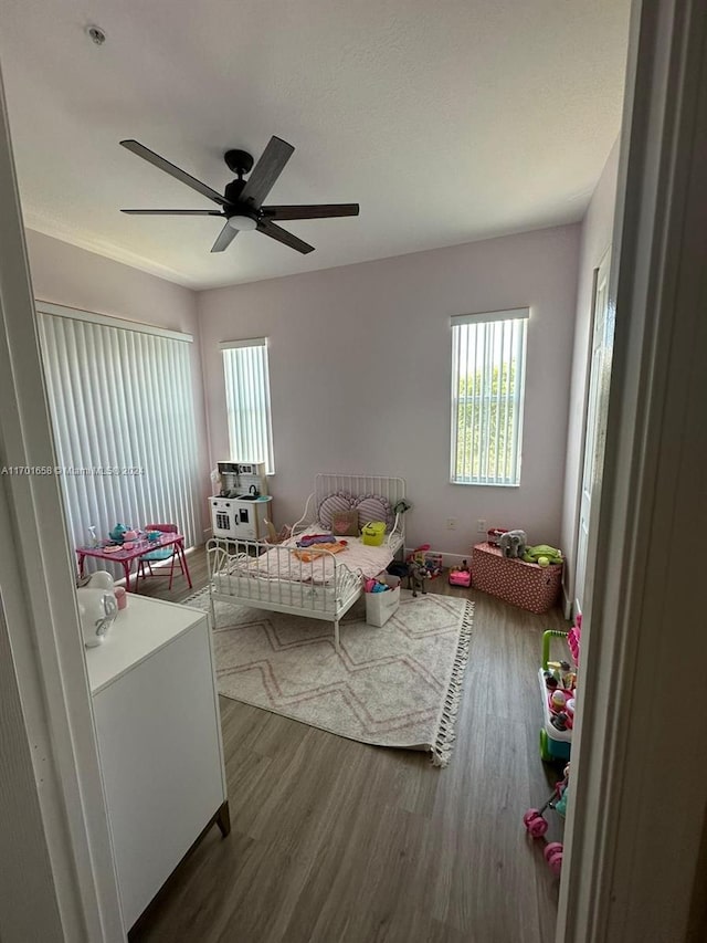 bedroom with ceiling fan and dark wood-type flooring