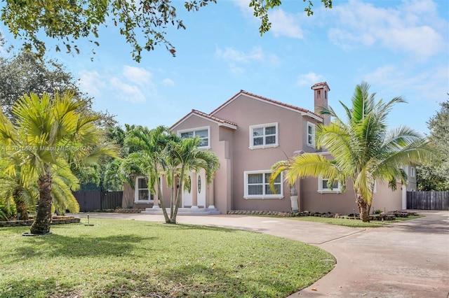 mediterranean / spanish-style home featuring a front yard