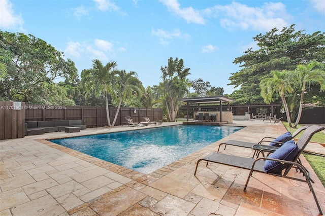 view of pool featuring outdoor lounge area and a patio