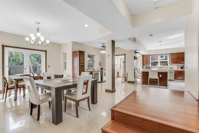 dining room featuring light tile patterned floors and ceiling fan with notable chandelier