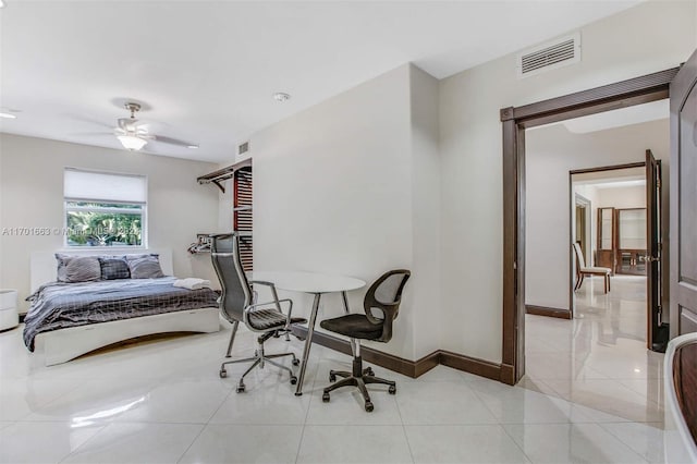 tiled bedroom featuring ceiling fan