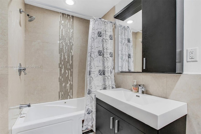 bathroom featuring vanity, shower / bath combo, and tile walls