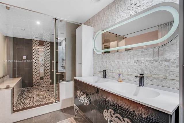 bathroom with tile patterned flooring, vanity, tile walls, and a shower with shower door