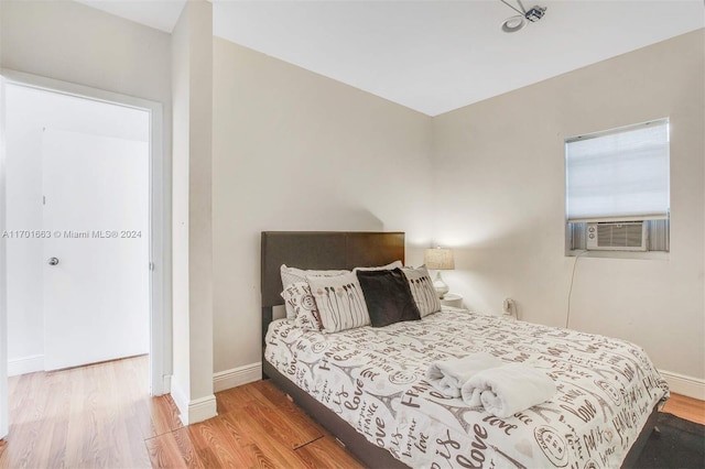 bedroom featuring hardwood / wood-style flooring and cooling unit