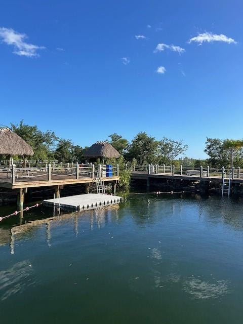 view of dock featuring a gazebo and a water view