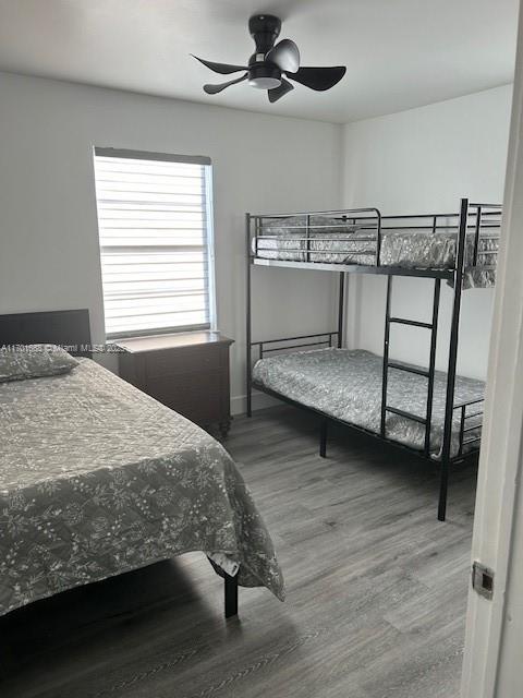 bedroom with hardwood / wood-style flooring and ceiling fan