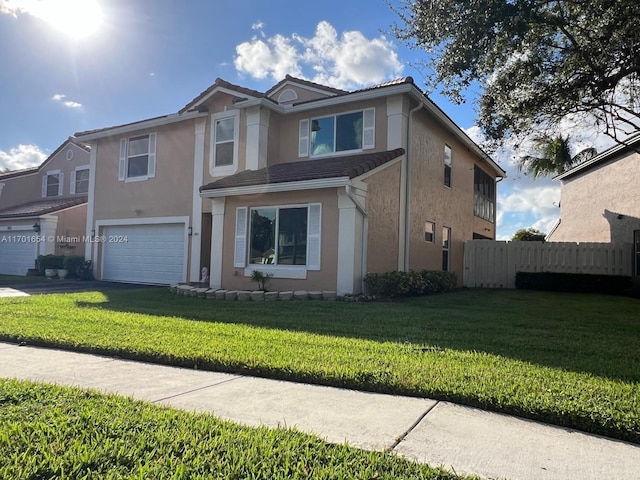 view of front property with a garage and a front lawn