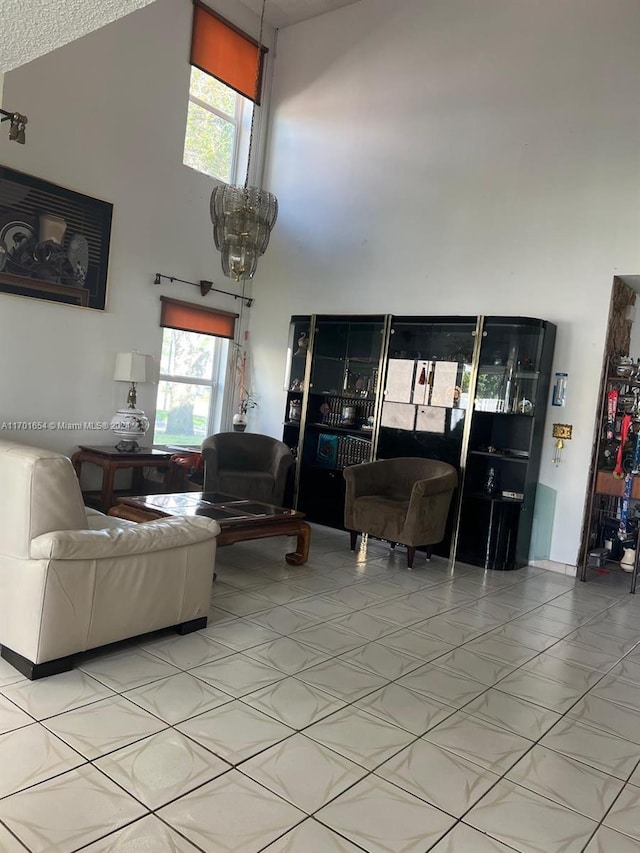 living room featuring a textured ceiling, high vaulted ceiling, and a wealth of natural light