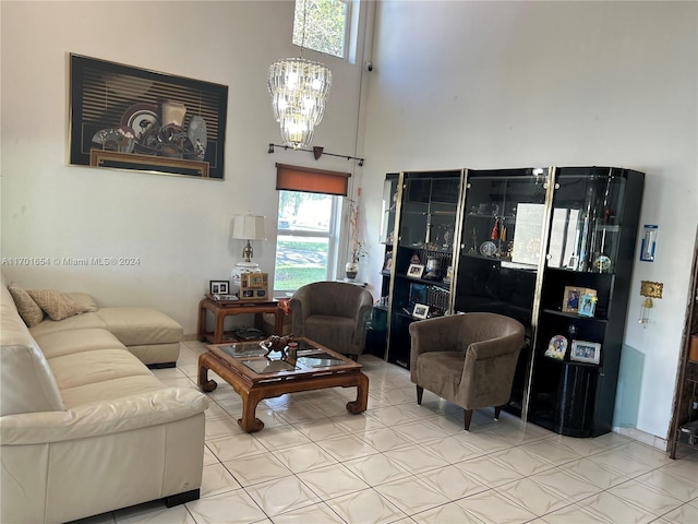 living room featuring a high ceiling and a chandelier