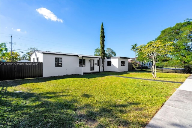 ranch-style home featuring a front yard