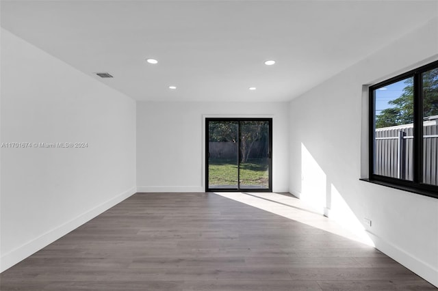 spare room featuring wood-type flooring