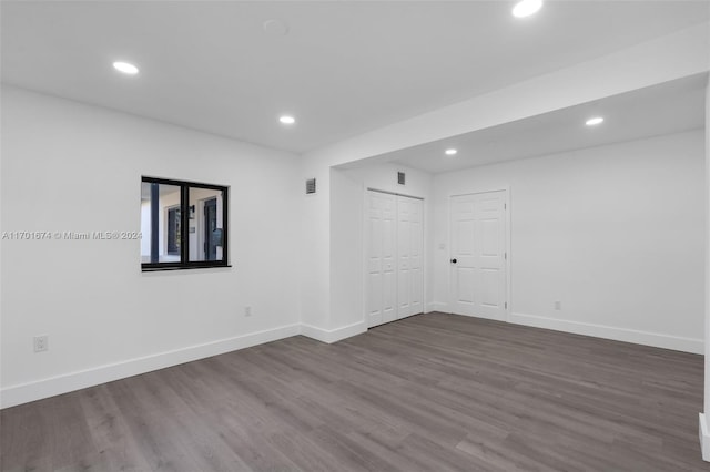 empty room with dark hardwood / wood-style floors