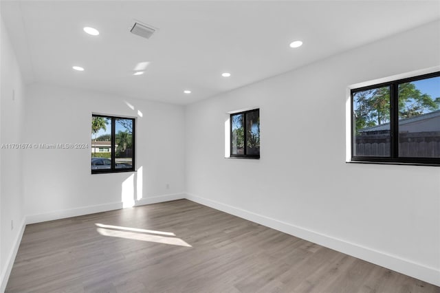 unfurnished room with wood-type flooring and plenty of natural light