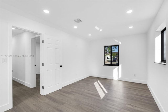 spare room featuring dark wood-type flooring